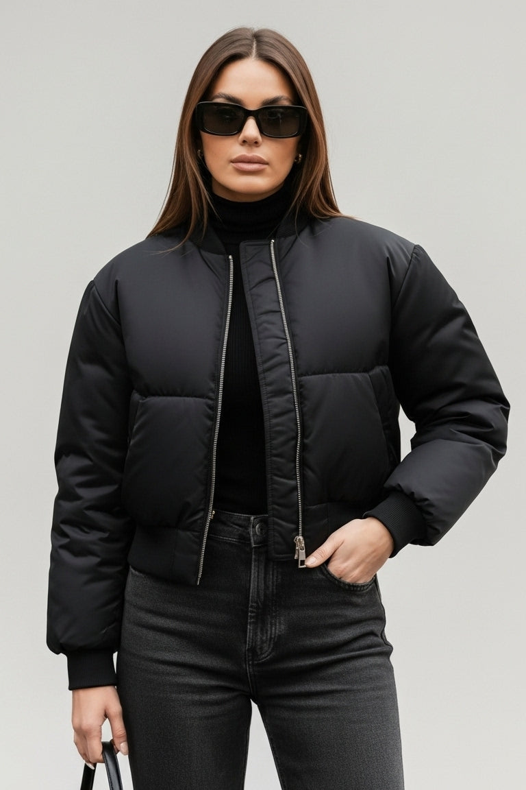 Side profile of CAELIA Oversized Bomber Jacket showing baseball collar and oversized sleeve cut.
