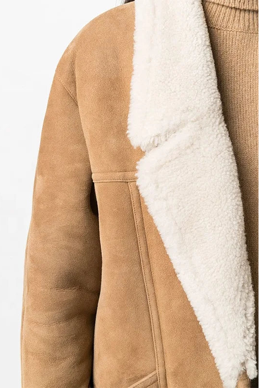 Side profile of the NELVIA warm padded coat highlighting pockets and quilted construction.