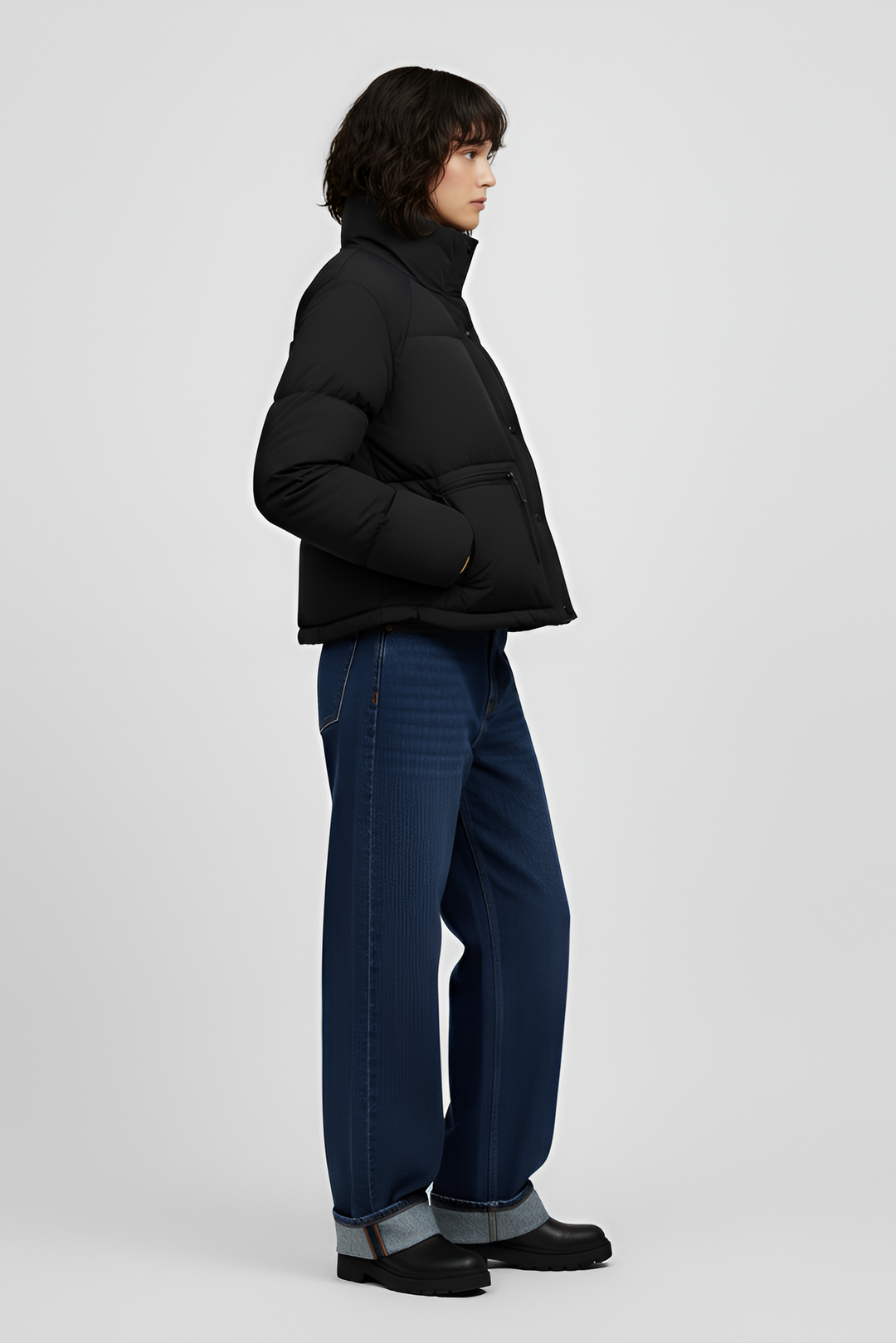 Woman wearing a red jacket and black jeans on a white background