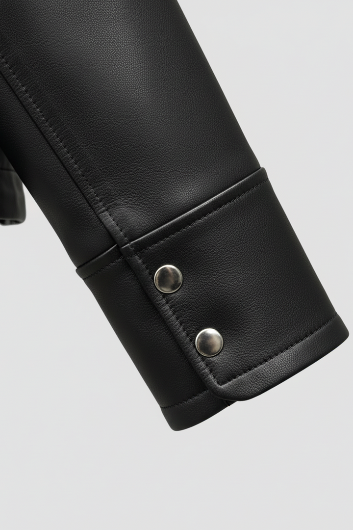 WAVERLY - Close-up of the cuff on a black sheepskin leather jacket with silver snap buttons