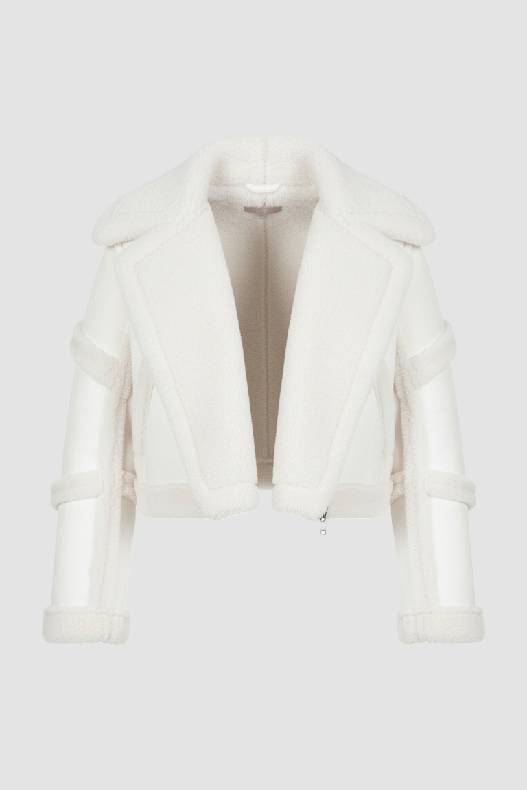 White fur coat on a mannequin against a white background