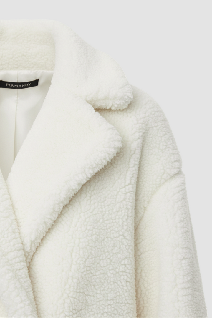 White fur coat with a brand label on a white background
