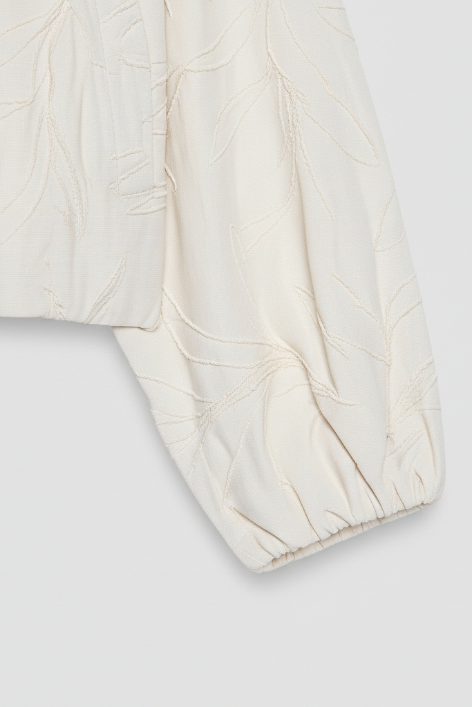 White quilted jacket on a light gray background