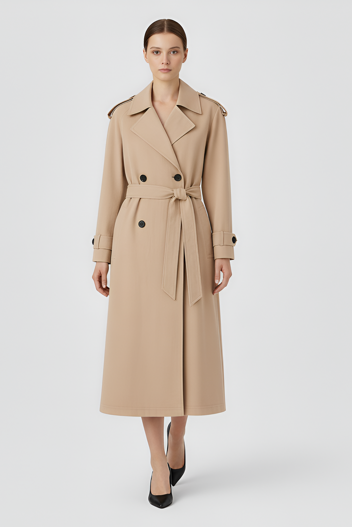 Woman wearing a beige trench coat on a light gray background