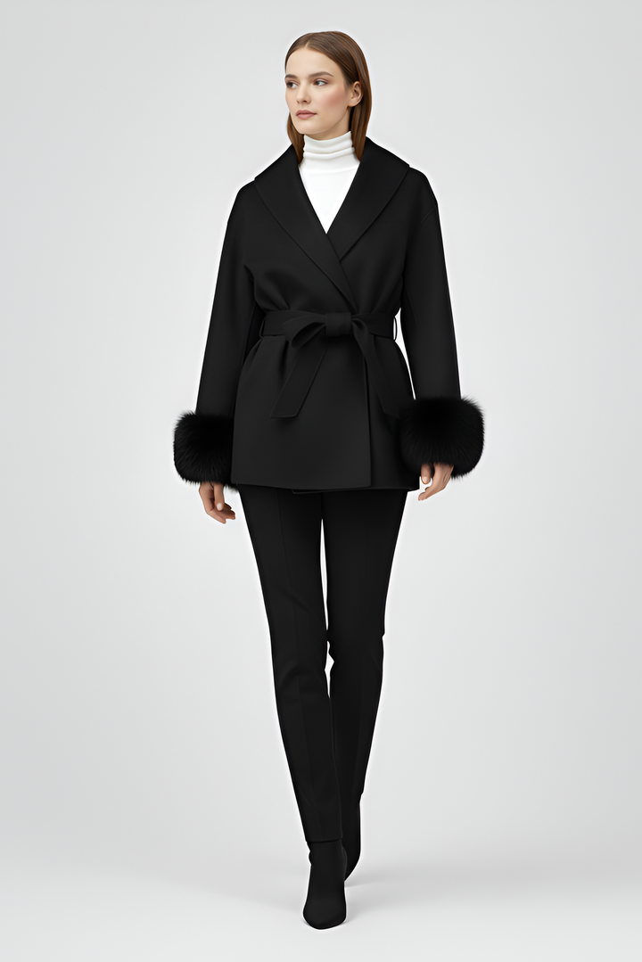 Woman wearing a black coat with fur trim on a white background