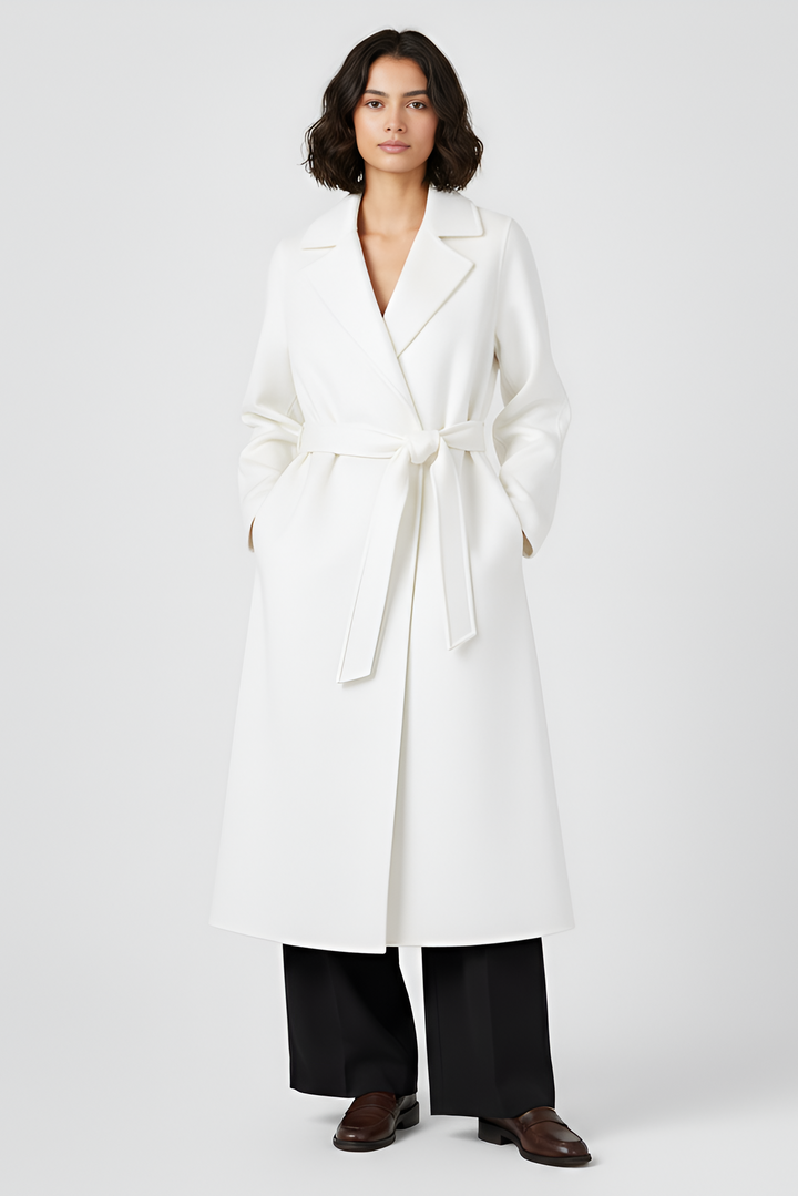 Woman wearing a white coat on a plain background