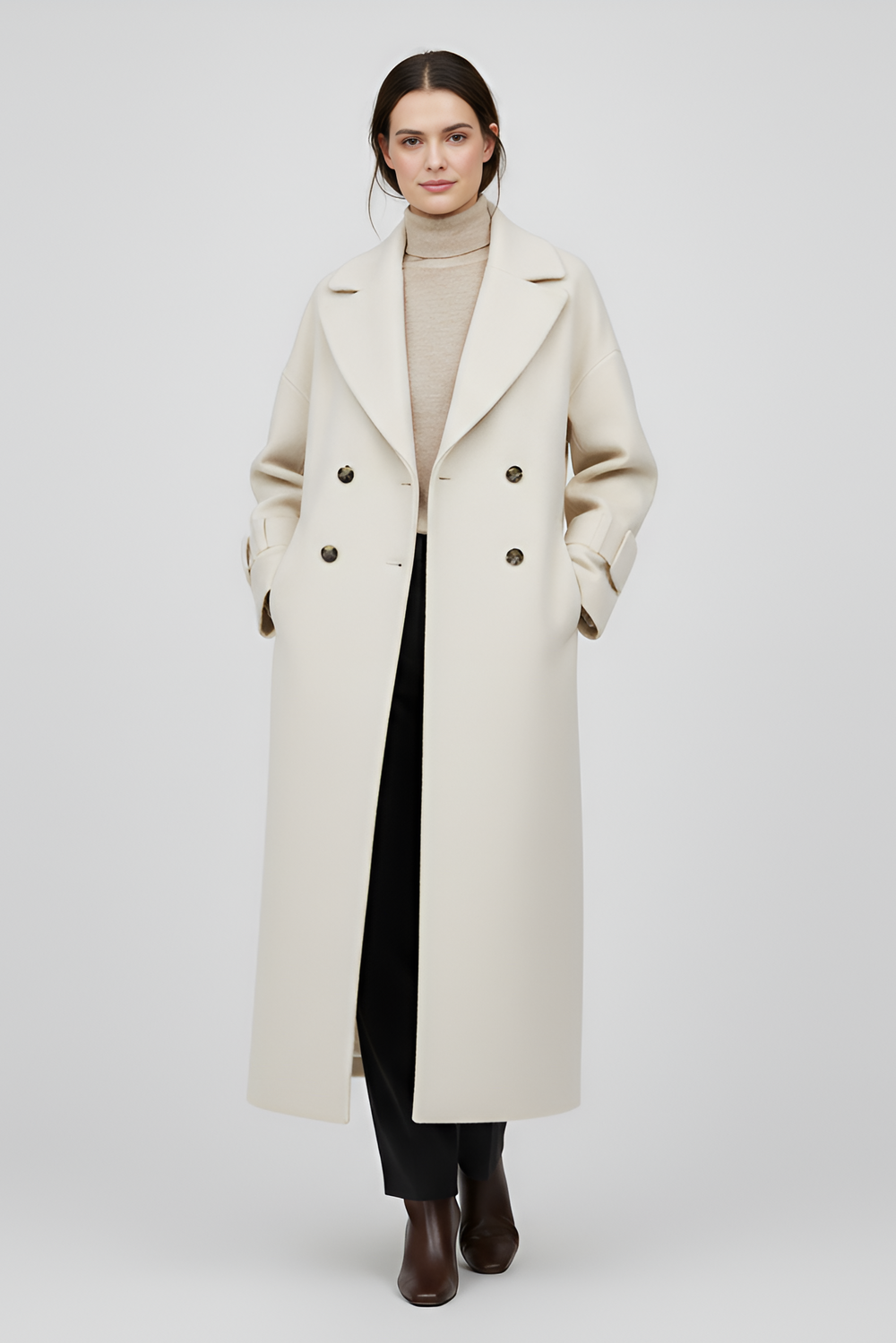 Woman wearing a long beige coat on a white background