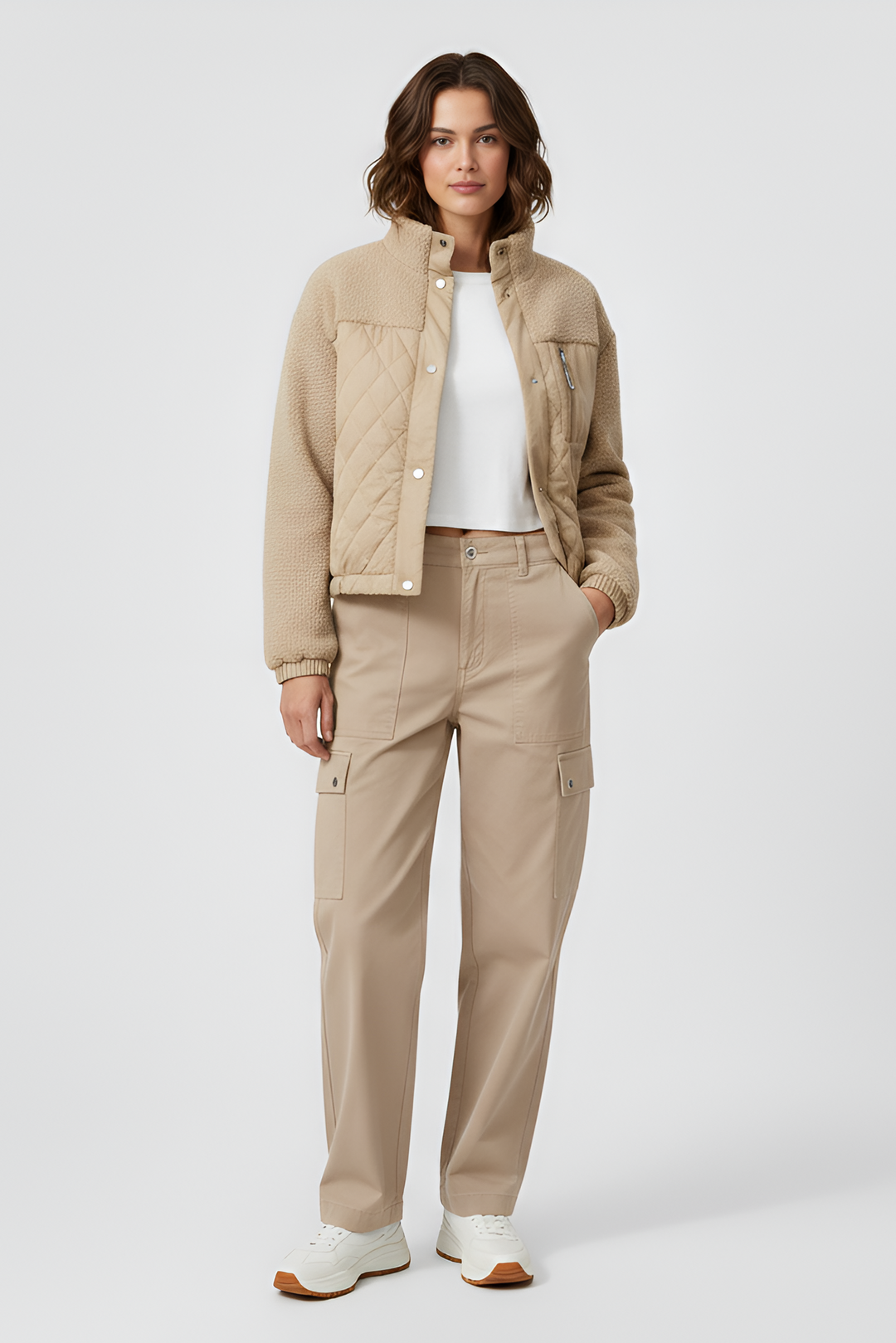 Woman wearing a beige jacket and pants on a white background