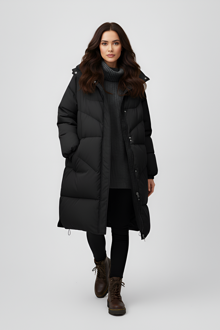 Woman wearing a black puffer coat on a white background