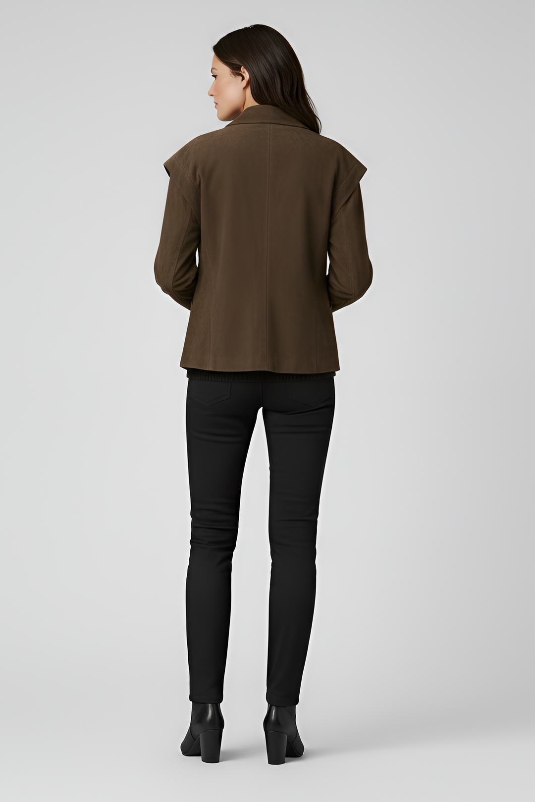 Woman wearing a brown jacket and black pants on a white background