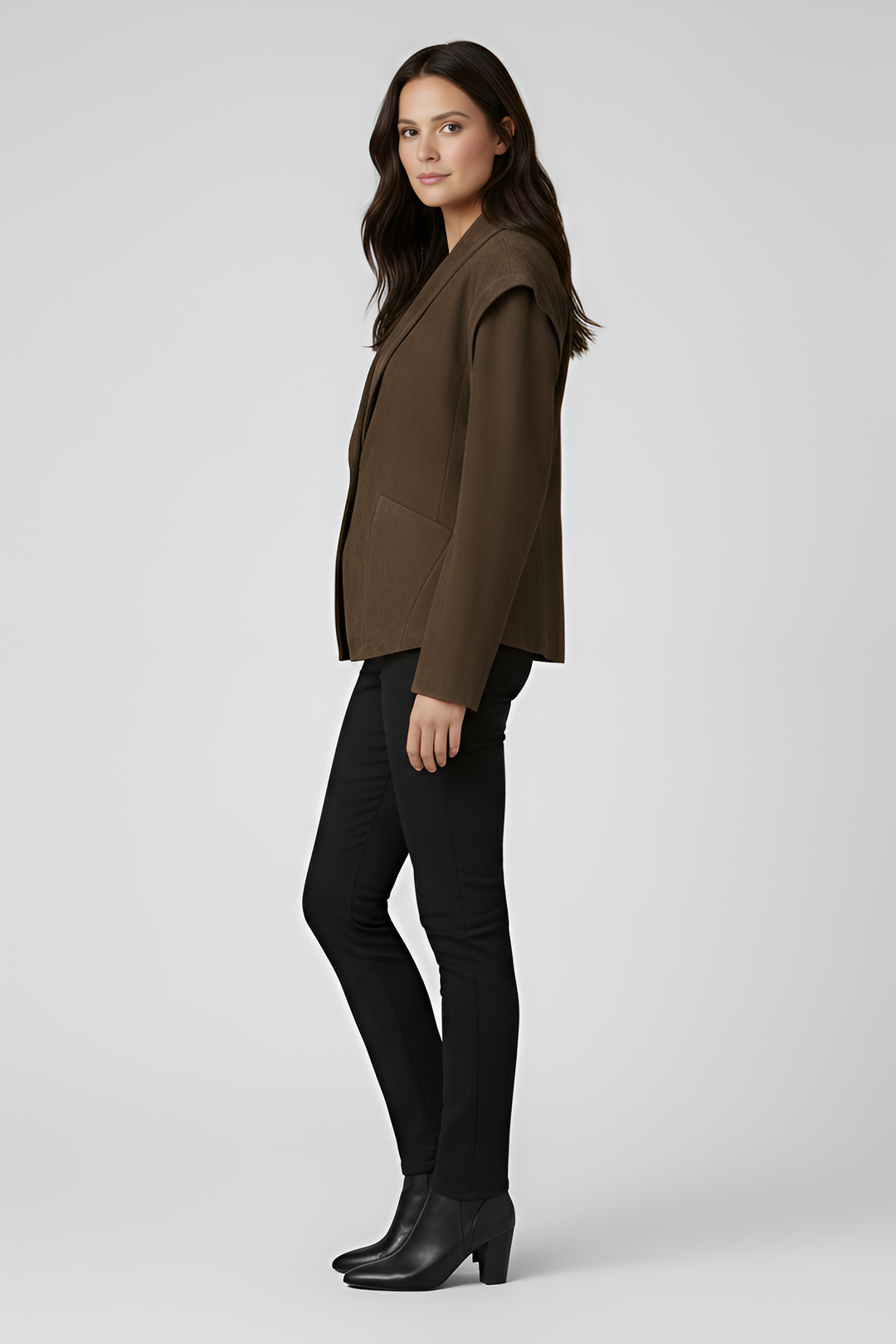 
Woman wearing a brown jacket and black pants on a white background
