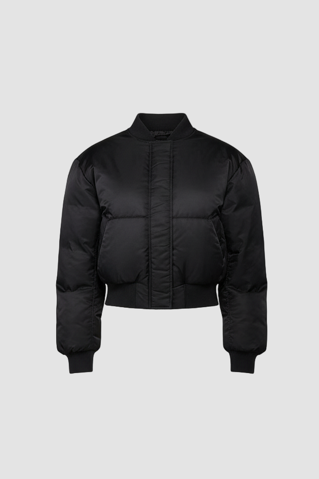 Woman wearing CAELIA Oversized Bomber Jacket in black, showing structured shoulders and cropped silhouette.