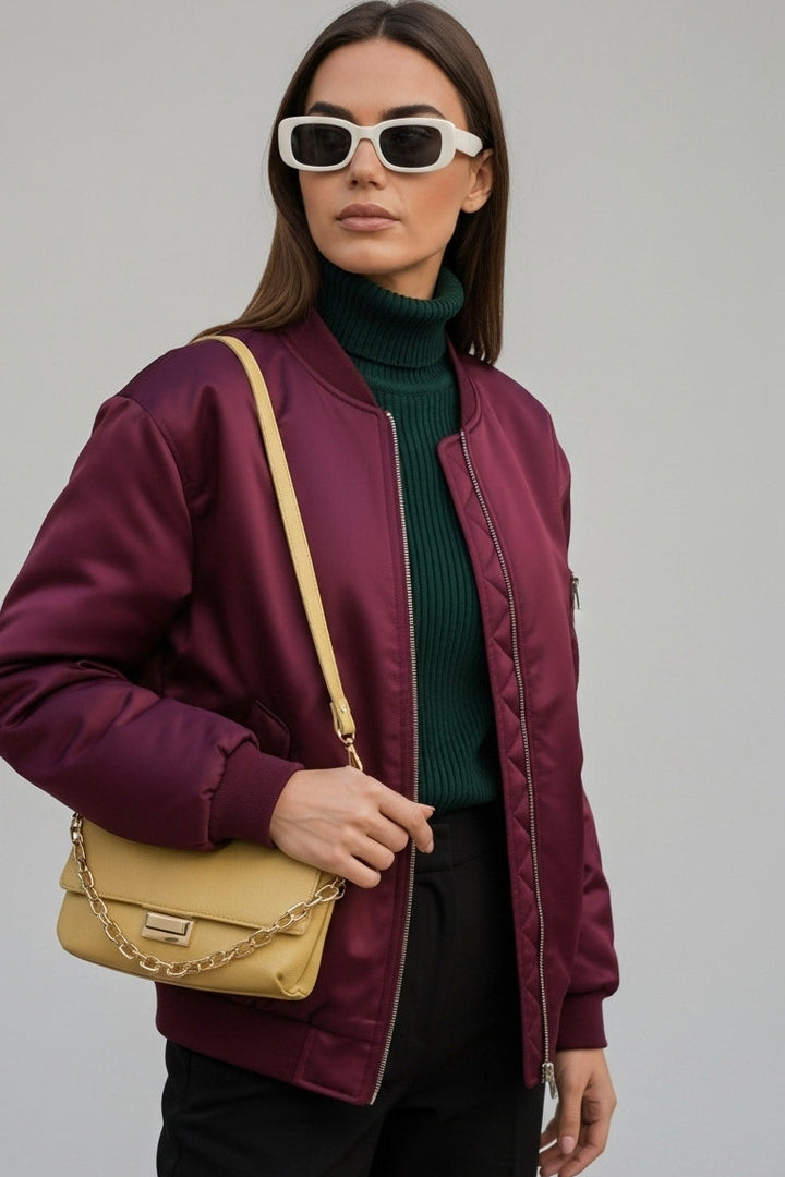 Woman wearing LYRIEL Purple Puffer Bomber Jacket with baseball collar and zip-front closure.