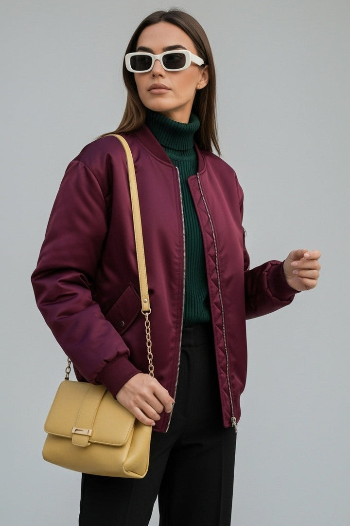Woman wearing LYRIEL Purple Puffer Bomber Jacket with baseball collar and zip-front closure.