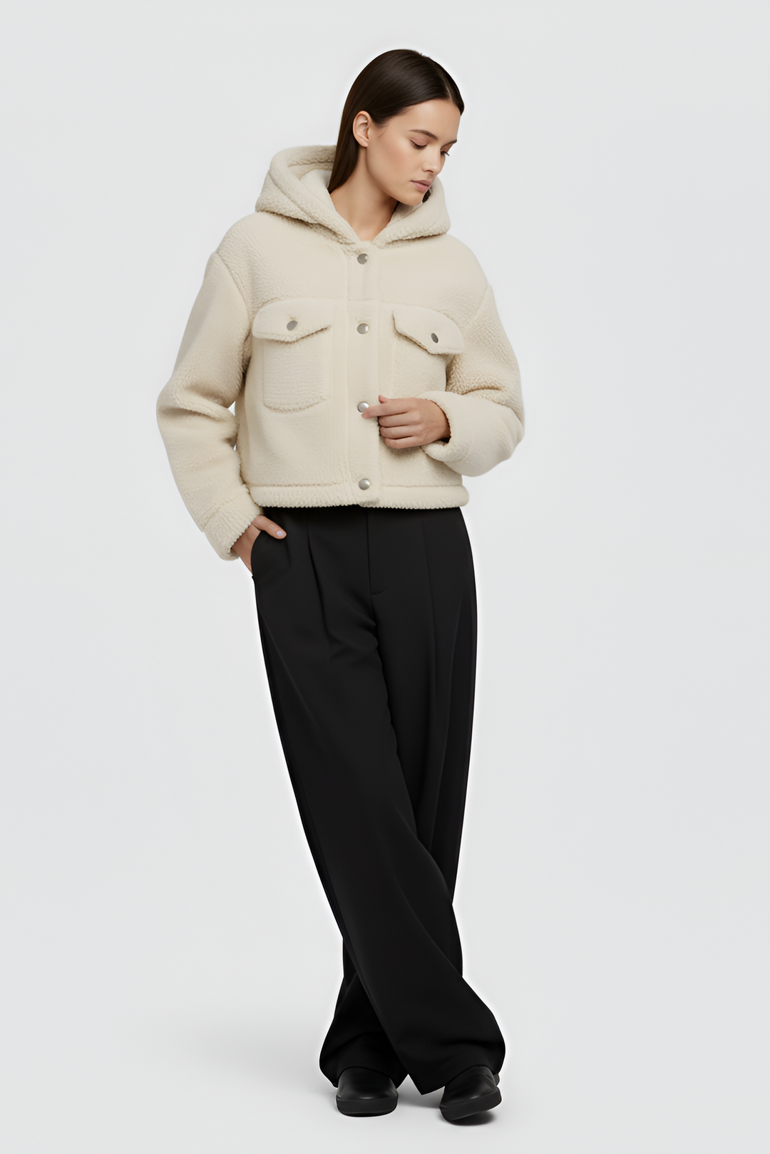 Woman wearing MYRALI Winter Fleece Jacket in cream, front studio view.