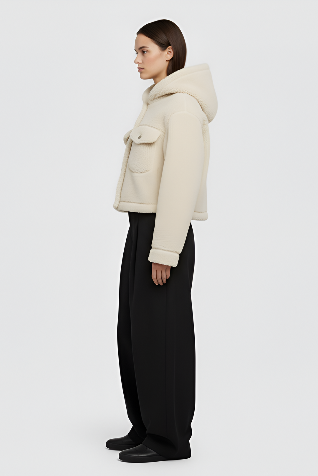 Woman wearing MYRALI Winter Fleece Jacket in cream, front studio view.