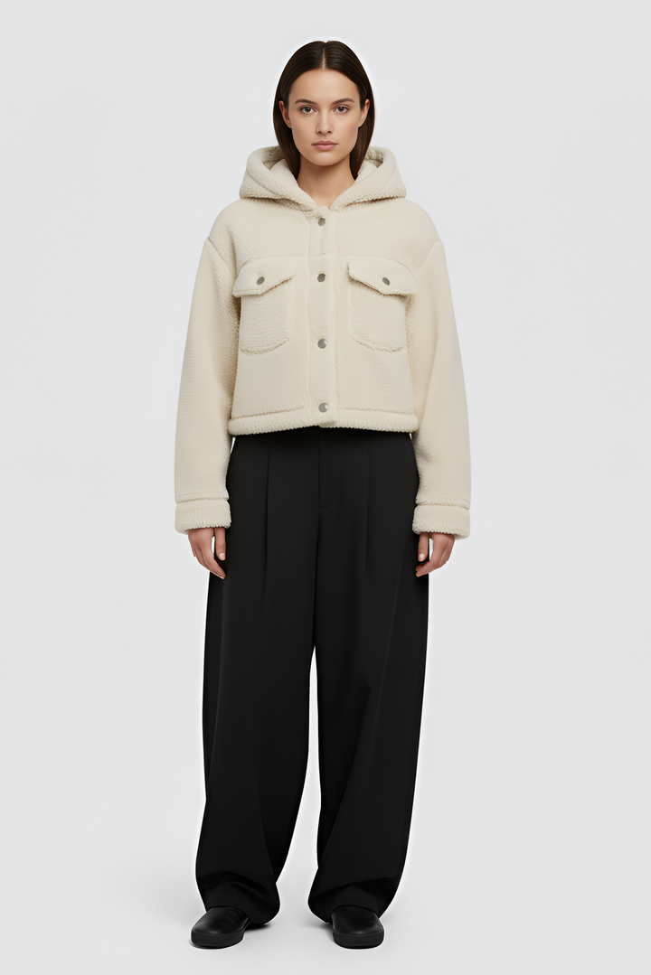 Woman wearing MYRALI Winter Fleece Jacket in cream, front studio view.