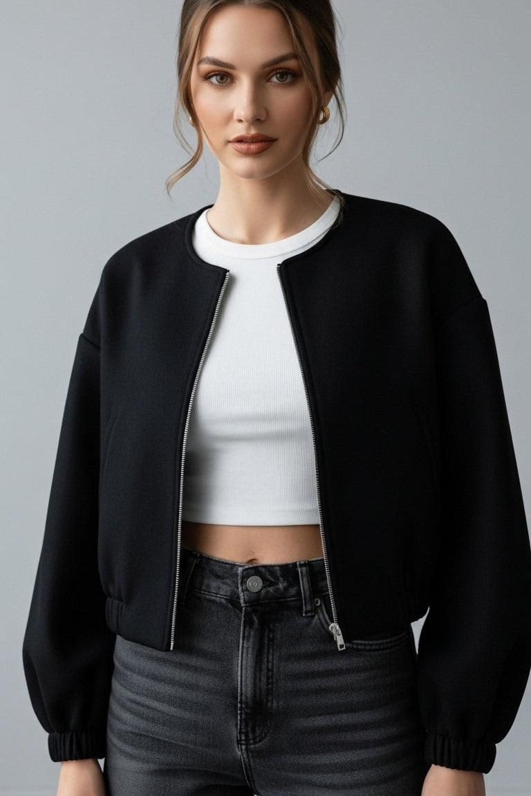 Woman wearing VALERINE Velvet Bomber Jacket in black, showing drop shoulders and zip-front design.