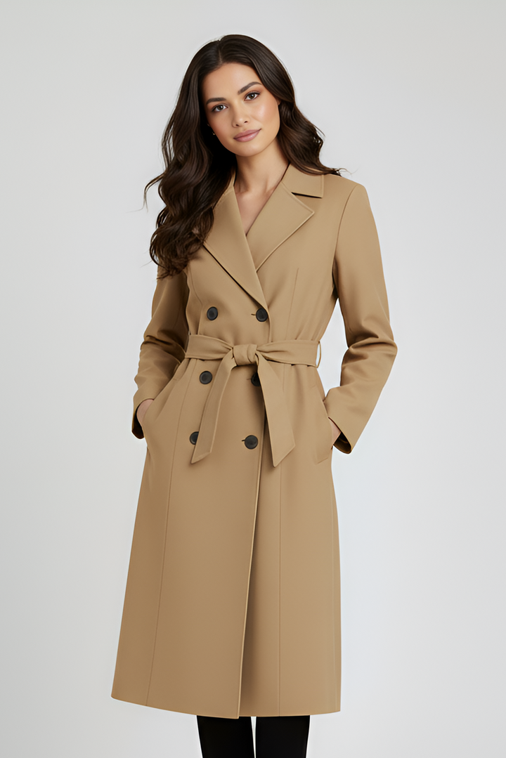 Woman wearing a beige trench coat on a white background