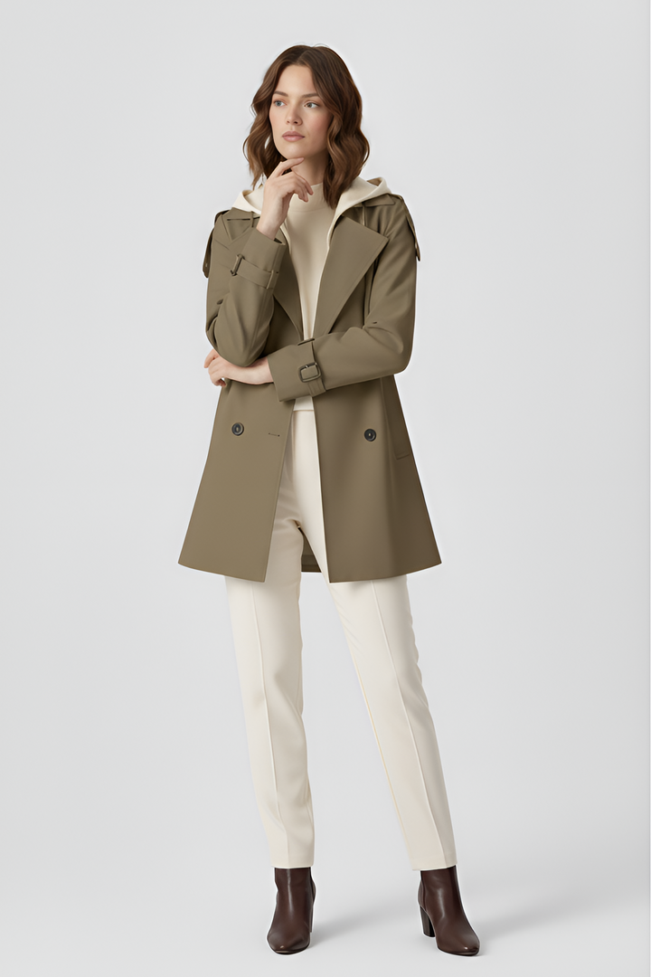 Woman wearing a beige trench coat on a light gray background