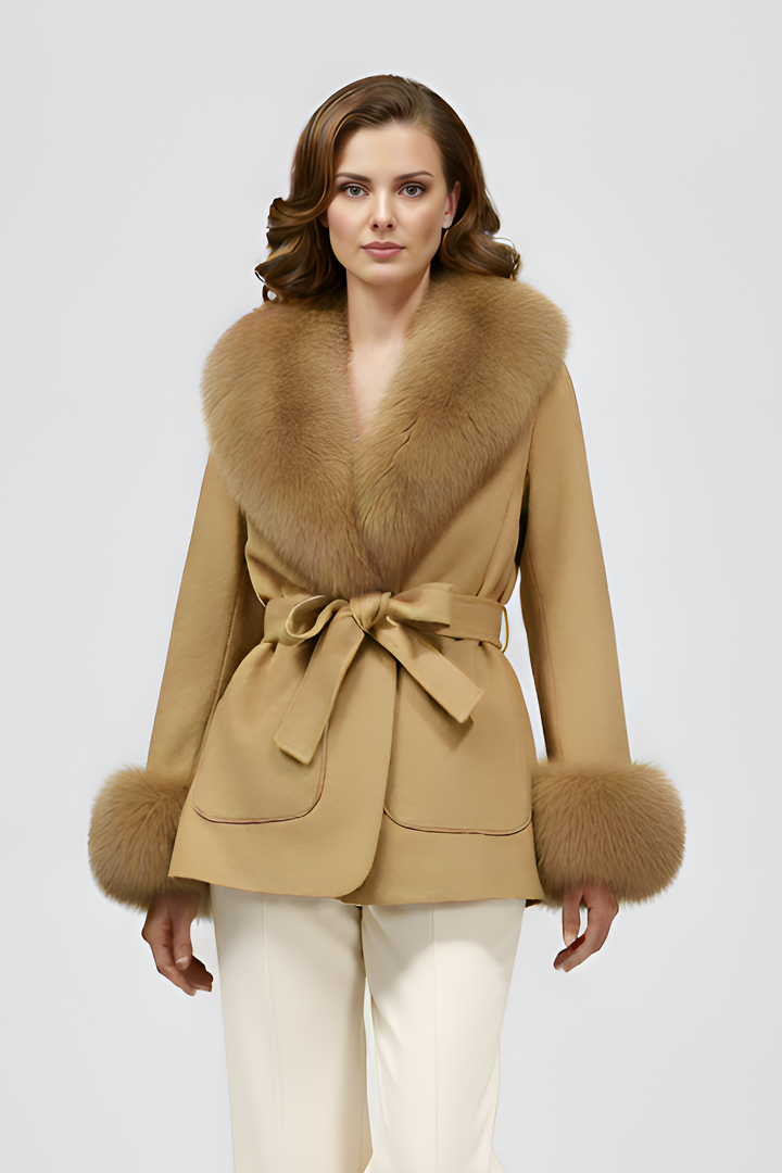 Woman wearing a beige coat with fur trim on a white background