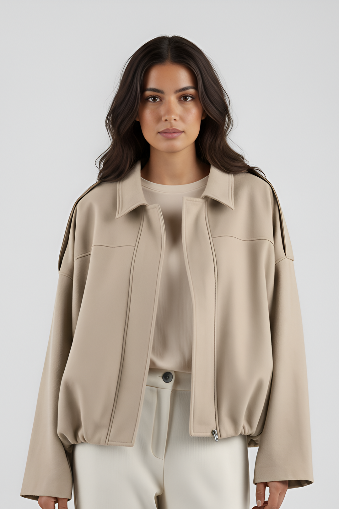 Woman wearing a beige jacket on a white background