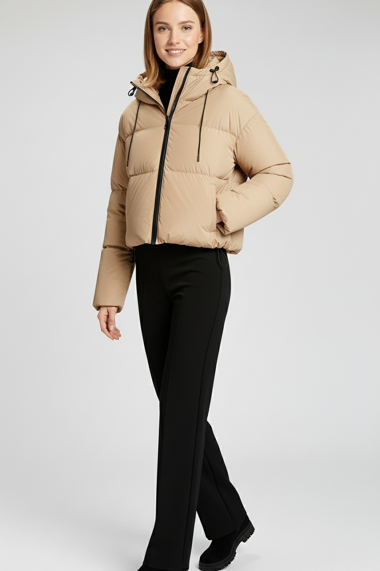 Woman wearing a beige puffer jacket on a white background