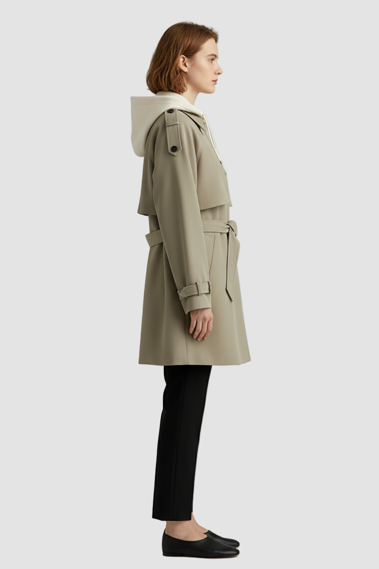 Woman wearing a beige trench coat on a light gray background