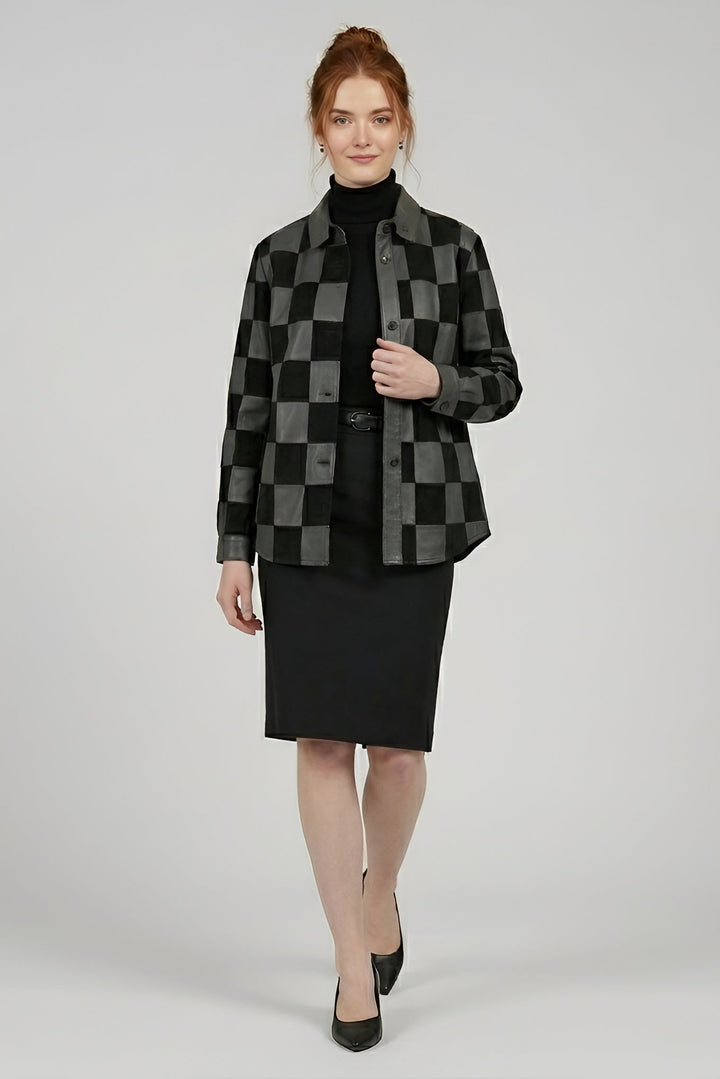Woman wearing a black and gray checkered jacket with a black skirt on a white background