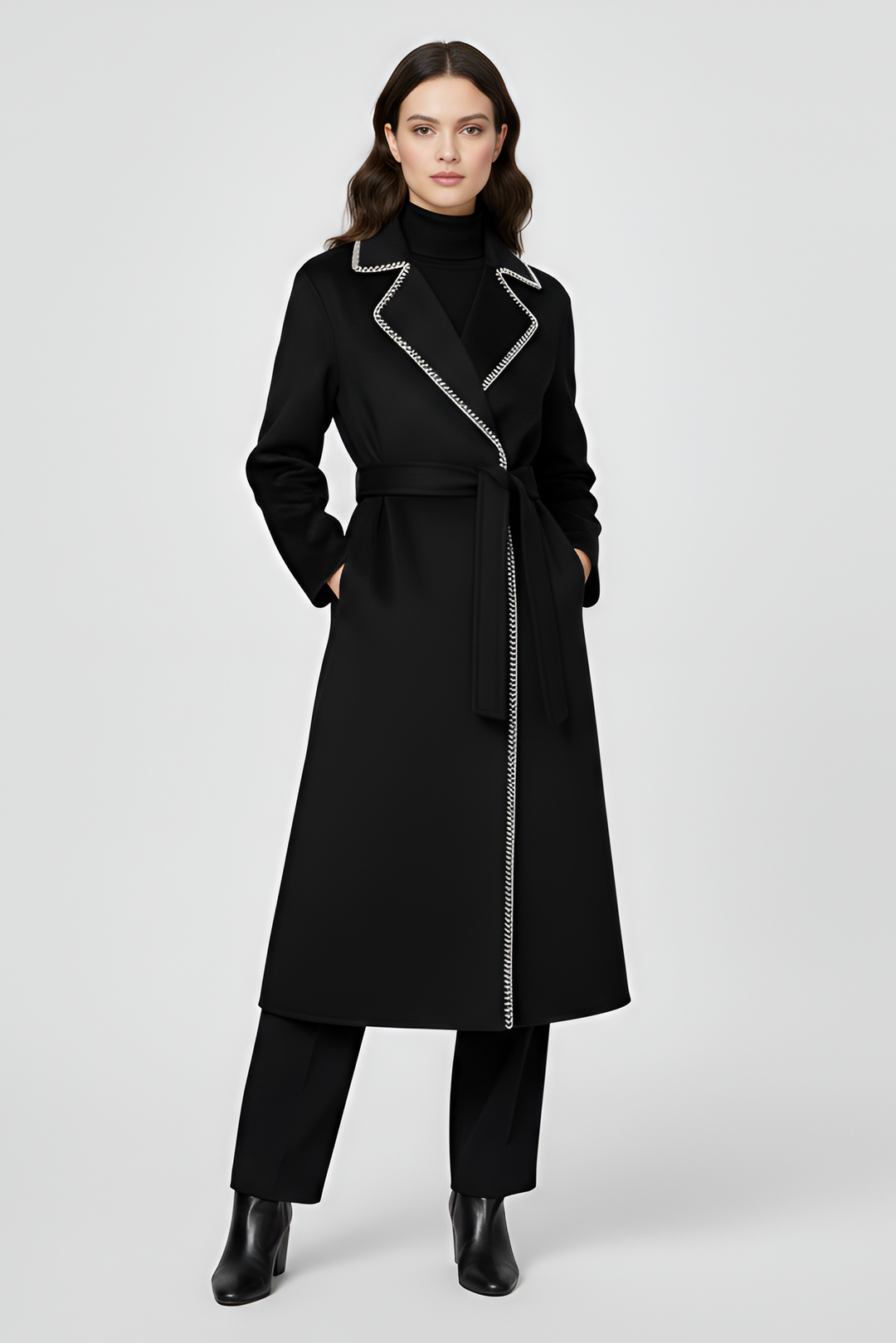 Woman wearing a black coat with silver zipper on a white background