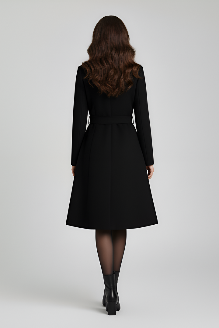 Woman wearing a black coat from behind on a light gray background