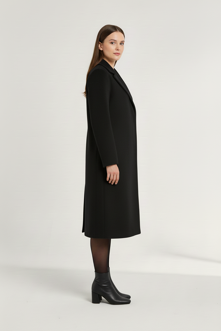 Woman wearing a black coat on a white background