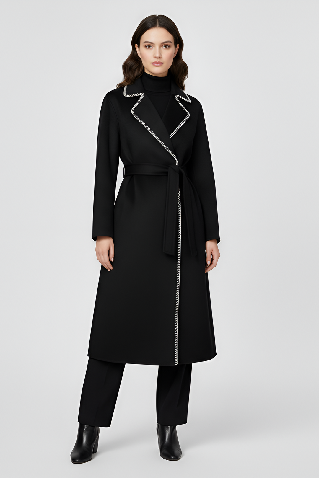 Woman wearing a black coat with silver zipper on a white background