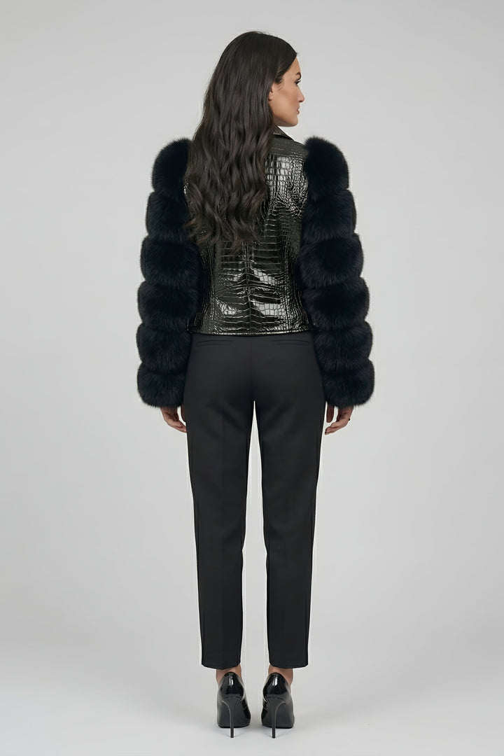 Woman wearing a black fur coat with a sequined back on a gray background