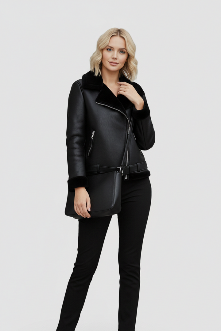 Woman wearing a black leather jacket and pants on a white background
