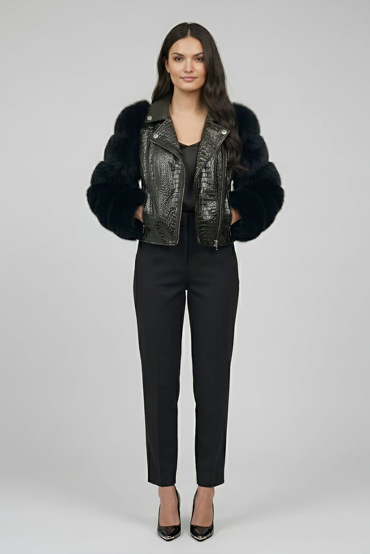 Woman wearing a black leather jacket with fur trim on a gray background