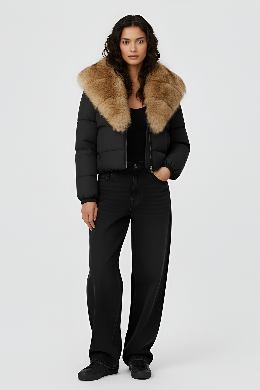 Woman wearing a black puffer jacket with a fur hood on a white background