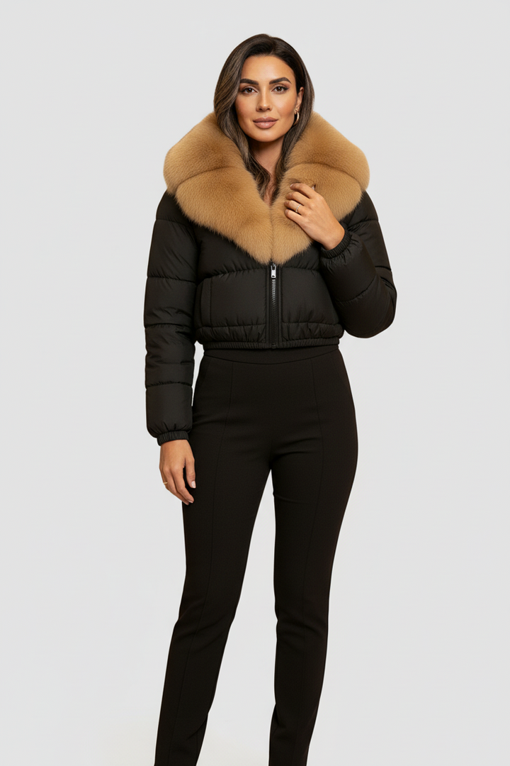Woman wearing a black puffer jacket with a fur hood on a white background