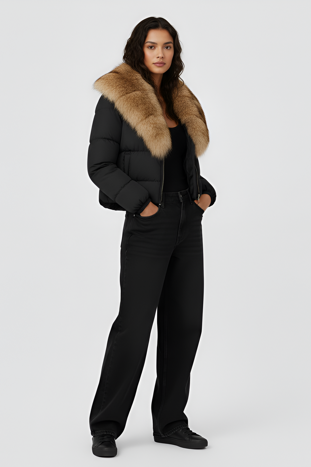 Woman wearing a black puffer jacket with a fur hood on a white background
