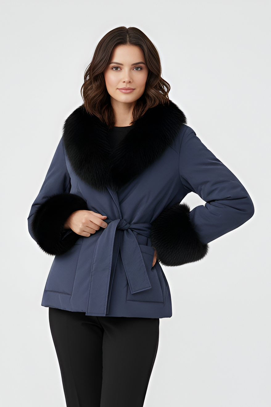 Woman wearing a blue coat with fur trim on a white background