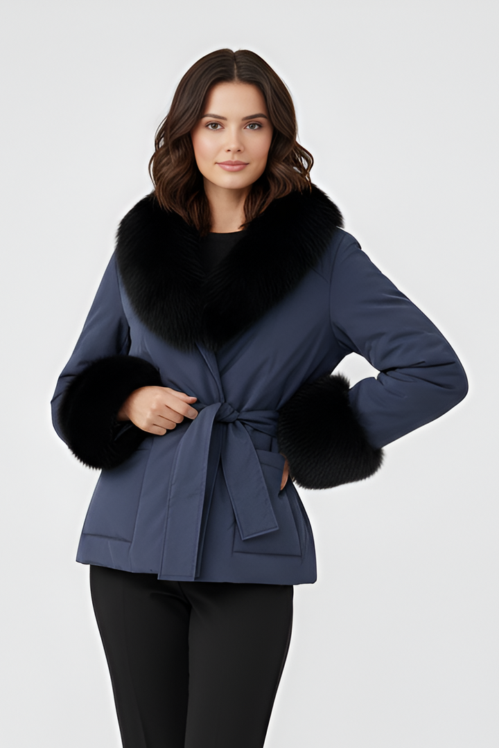 Woman wearing a blue coat with fur trim on a white background