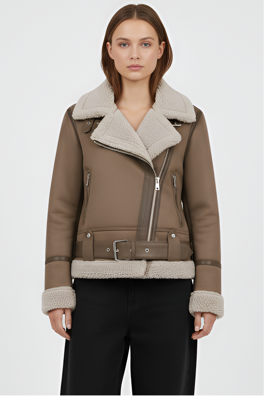 Woman wearing a brown shearling jacket and pants on a light gray background