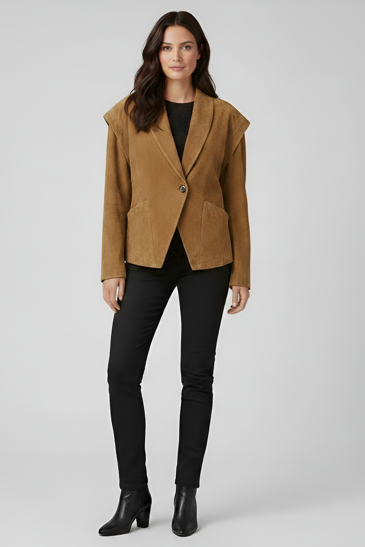 Woman wearing a brown jacket, black pants, and black boots on a white background