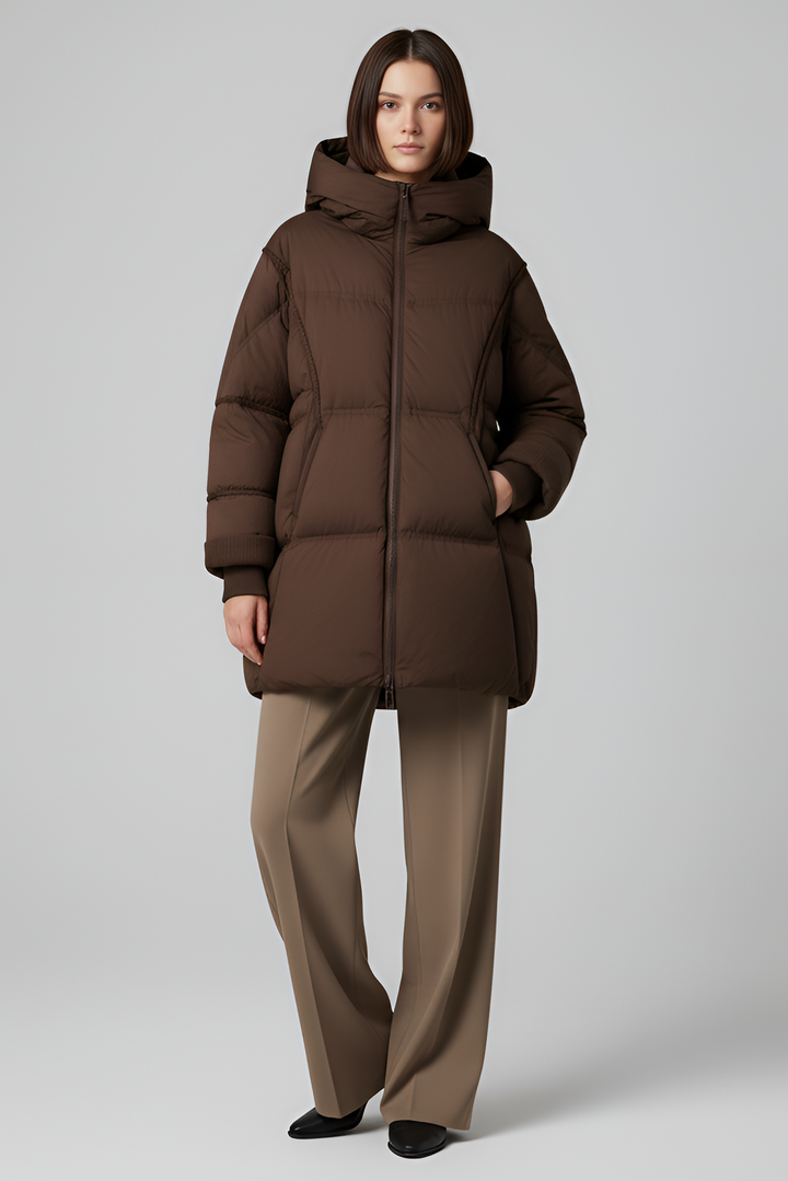 Woman wearing a brown puffer jacket against a white background