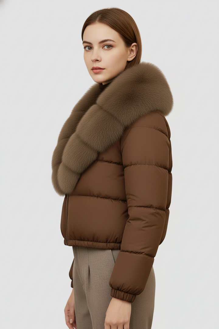 Woman wearing a brown puffer jacket with a fur collar on a white background