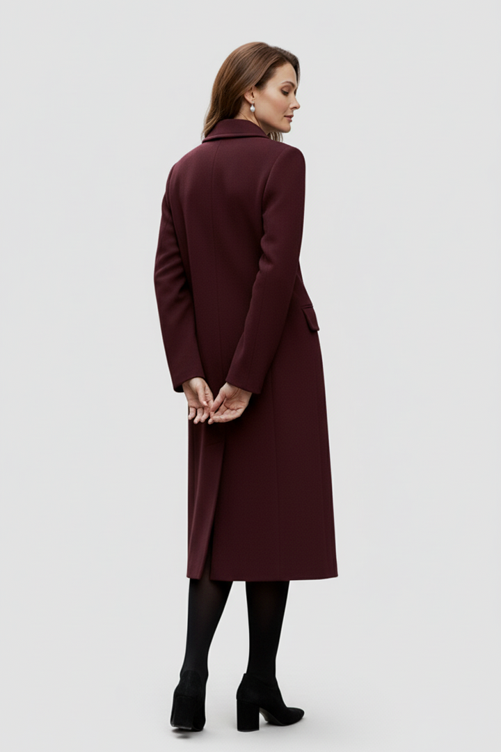 Woman wearing a burgundy coat on a white background