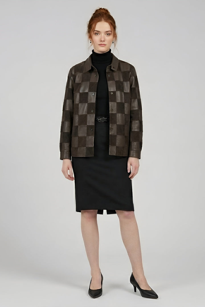 Woman wearing a checkered brown jacket over a black outfit on a white background