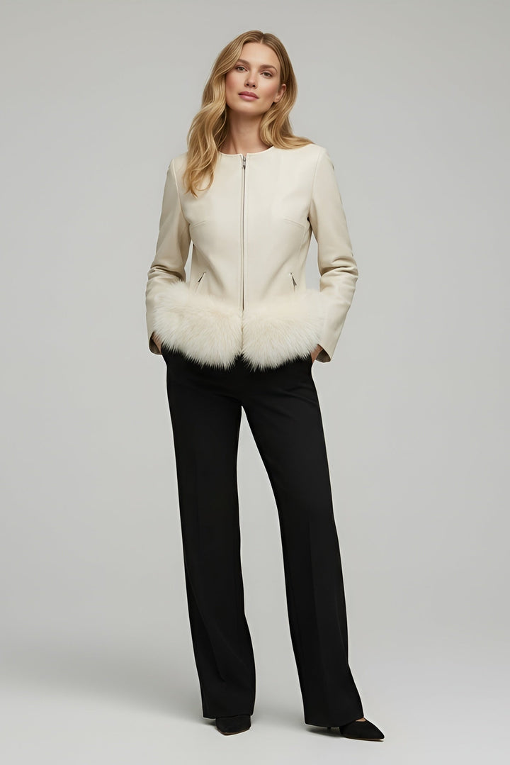 Woman wearing a cream jacket with fur trim on a gray background
