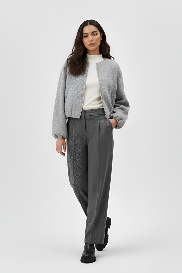 Woman wearing a gray outfit with a white background