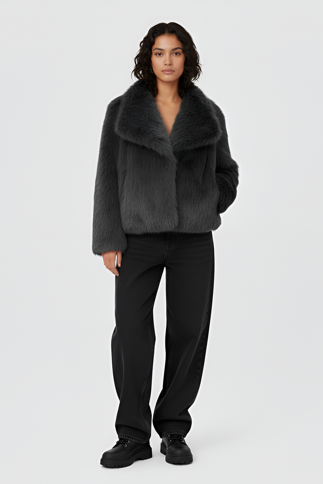 Woman wearing a gray sweater and white skirt on a plain background